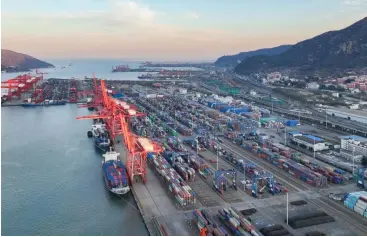  ?? ?? Aerial photo taken on Dec. 1, 2021 shows the container terminal in Lianyungan­g, east China’s Jiangsu Province.
(Photo by Si Wei/Xinhua)