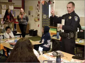  ?? JOEL ROSENBAUM / THE REPORTER ?? Vacaville Police Department Lt. Aaron Dahl speaks Thursday with the third graders in Katie Vaclavik's class at Eugene Padan Elementary School during his monthly visit with the kids. Dahl, who attended Padan, adopted the class at the beginning of the school year. Thursday he read to the students about Jackie Robinson, spoke about courage and allowed them to see police vehicles up close.