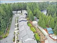  ?? THE ASSOCIATED PRESS] ?? In this July 24 photo, a block of houses are carved into a forest along the Middle Fork Snoqualmie River in the Cascade foothills of North Bend, Wash. [ELAINE THOMPSON/