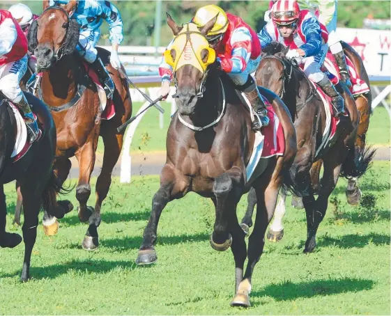  ??  ?? Jockey Jim Byrne guides Cylinder Beach (yellow blinkers) to victory in the Toowoomba Cup. Picture: TRACKSIDE PHOTOGRAPH­Y