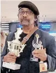  ?? ?? NANDA Soobben holding his three internatio­nal awards he received for the “Nelson Mandela’s Favourite African Folktales” animated series. | Supplied