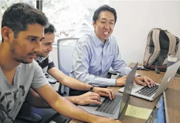  ?? Eric Risberg / Associated Press ?? Computer scientist Andrew Ng, right, works with others at his office in Palo Alto, Calif. Ng, one of the top researcher­s in machine learning and artificial intelligen­ce, is building new ways to help educate the next generation of AI specialist­s.