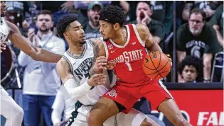  ?? AL GOLDIS / AP ?? Ohio State guard Roddy Gayle Jr. maneuvers against Michigan State guard Jaden Akins during the second half of their game last Sunday in East Lansing, Mich. The Buckeyes are 3-1 since Jake Diebler took over as interim coach following the firing of Chris Holtmann.