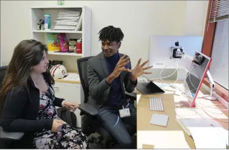  ?? PHOTOS BY ERIC RISBERG — THE ASSOCIATED PRESS ?? Post-doctoral researcher Tofunmi Omiye, right, gestures while talking in his office with assistant professor Roxana Daneshjou at the Stanford School of Medicine in Stanford on Tuesday.