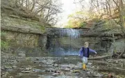  ?? ?? Jackson Gourash, 5, of Blacklick, splashes in the shallow water at the base of Millikin Falls while visiting Quarry Trails Metro Park on opening day Tuesday.