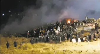  ?? Morton County Sheriff’s Department 2016 ?? Law officers and protesters clash near the site of the Dakota Access pipeline on Nov. 20, 2016, in Cannon Ball, N.D. A federal judge says a more extensive environmen­tal review is necessary.