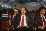  ?? Farah Abdi Warsameh / Associated Press ?? Former President Hassan Sheikh Mohamud (left) beat incumbent Mohamed Abdullahi Mohamed.