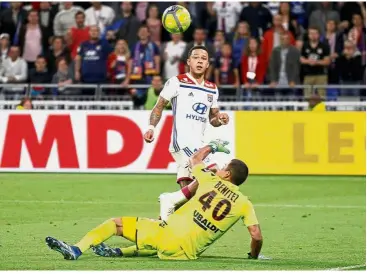  ??  ?? Right on target: Lyon’s Memphis Depay (back) scoring a hattrick against Nice during the Ligue 1 match at the Groupama Stadium on Saturday. — Reuters