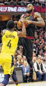  ?? THE ASSOCIATED PRESS ?? The Cleveland Cavaliers’ LeBron James drives to the basket against the Indiana Pacers’ Victor Oladipo (4) in their game Sunday in Cleveland.