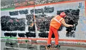  ?? PTI ?? A UP administra­tion worker paints a wall bearing political advertisem­ent as the Model Code of Conduct has come into effect after the announceme­nt of the schedule of UP Assembly elections, in Meerut on Sunday. —