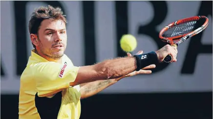  ?? Photo: REUTERS ?? Eyes on the ball: Stan Wawrinka, of Switzerlan­d, returns a shot during his French Open first round match against Spain’s Guillermo Garcia-Lopez at the Roland Garros stadium yesterday.