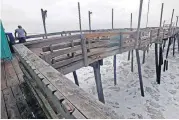  ?? [AP PHOTO] ?? Waves crash under the Avalon Fishing Pier on Thursday in Kill Devil Hills, N.C., as Hurricane Florence approaches the east coast.