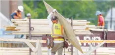  ?? — Reuters ?? Constructi­on workers are seen at a new building site in Maryland.