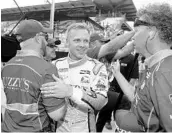  ?? MICHAEL CONROY/ASSOCIATED PRESS ?? Ed Carpenter celebrates with his crew after he qualified with Saturday’s fastest time for the Indianapol­is 500.