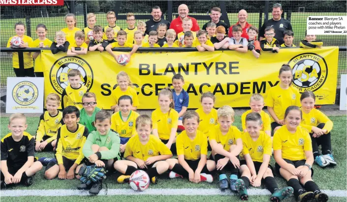  ??  ?? Banner Blantyre SA coaches and players pose with Mike Phelan
240718socc­er_22