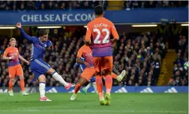  ?? — AFP ?? Chelsea’s Eden Hazard (left) scores against Manchester City in their English Premier League match at Stamford Bridge in London on Wednesday. The hosts won 2-1.