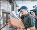  ?? Dennis M. Rivera Pichardo The Associated Press ?? A messenger representi­ng Gov. Pedro Pierluisi’s attorneys delivers paperwork Tuesday in San Juan, Puerto Rico.