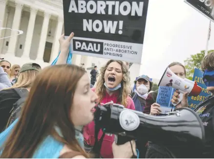  ?? ANNA MONEYMAKER / GETTY IMAGES ?? Pro-choice and anti-abortion activists demonstrat­e in front of the U.S. Supreme Court Building in Washington on Tuesday, as a leaked draft majority opinion that would see the landmark abortion-rights case Roe v. Wade overturned sparked widespread backlash.