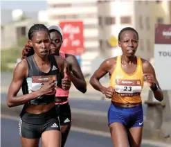  ??  ?? DAKAR: (From L) Second placed Naomi Tuei, third placed Kenyan Jacqueline Nyetipei and first placed Kenyan Zeddy Limo compete during the Dakar Marathon, yesterday, in Dakar. — AFP