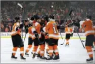  ?? MATT SLOCUM — THE ASSOCIATED PRESS ?? The Flyers’ Sean Couturier (14) celebrates with Scott Laughton (21), Michael Raffl (12), Ivan Provorov (9) and Jori Lehtera (15) after Couturier scored the winning goal in overtime Thursday in Philadelph­ia.