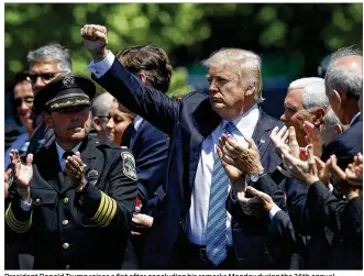 ?? WIN MCNAMEE / GETTY IMAGES ?? President Donald Trump raises a fist after concluding his remarks Monday during the 36th annual National Peace Officers’ Memorial Service on the west lawn of the U.S. Capitol. The service honors police officers who died in the line of duty and their...