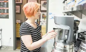  ??  ?? Gallery manager Megan Oliver makes a milkshake with Sacramento-based Gunther’s Ice Cream for a customer at Segale’s Double Dip Gallery.