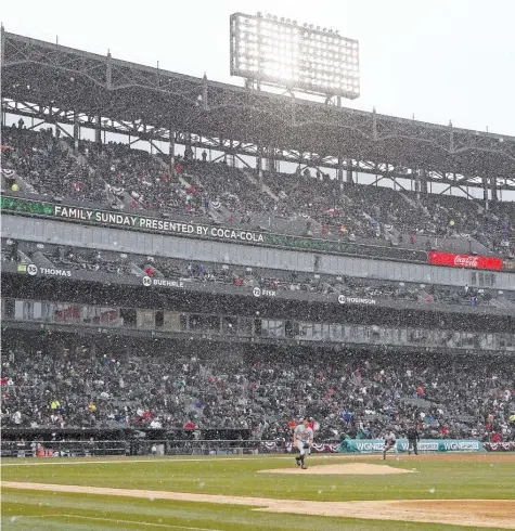  ?? JONATHAN DANIEL/ GETTY IMAGES ?? The Sox and Tigers played a baseball game Thursday in football weather. The Sox lost 9- 7 in 10 innings.