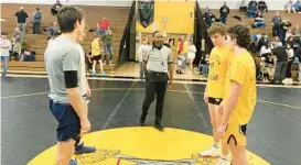  ?? BALTIMORE SUN MEDIA TIMOTHY DASHIELL/FOR ?? South Carroll and Gilman wrestling captains meet on the mat before their dual as part of Tuesday’s tri-meet that also included Spring Mills out of West Virginia.