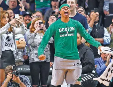  ?? WINSLOW TOWNSON / USA TODAY SPORTS ?? Boston Celtics guard Isaiah Thomas celebrates in the final moments of his team’s 112-94 win over the Milwaukee Bucks at TD Garden in Boston on Wednesday night. The win clinched the Celtics the No 1 seed in the NBA playoffs.