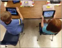  ?? DIGITAL FIRST MEDIA FILE PHOTO ?? Two students do activities on iPads in a classroom.