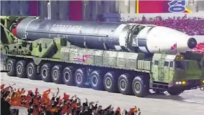  ?? KRT VIA AP ?? North Korean leader Kim Jong Un hosted a military parade with what appears to be possible new interconti­nental ballistic missile at the Kim Il Sung Square in Pyongyang on Saturday.