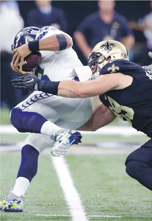  ?? — THE ASSOCIATED PRESS FILES ?? Paul Kruger and the New Orleans Saints kept Seattle Seahawks quarterbac­k Russell Wilson in check all game long Sunday en route to a 25-20 victory at the Superdome.