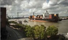  ?? STEPHEN B. MORTON, AP FILE PHOTO ?? The container ship Zim Istanbul makes its way up the Savannah River past historic River Street in Savannah. Visitors can enjoy cruises on the river along with sightseein­g in the city’s historic district, food tours and 22 squares that make for pleasant...