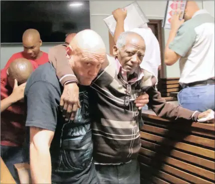  ??  ?? HELPING HAND: Isak Cupido is assisted by co-accused Jan van Wyk in the Kimberley Magistrate’s Court yesterday after the accused’s bail applicatio­n had to be postponed until today as Cupido had to receive medical treatment for a pre-existing...