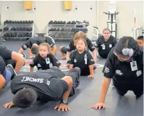  ?? ANTONIO SANCHEZ/JOURNAL ?? Jocelyn Garcia, left, and Adrianna Garcia look up at instructor­s while doing push-ups during the recent “Hero Academy” run by officers from the Albuquerqu­e Police Department.