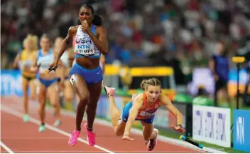  ?? ?? Alexis Holmes, of the USA anchors her team to the gold medal as Femke Bol, of the Netherland­s fell near the finish in the final of the 4x400-meters mixed relay during the World Athletics Championsh­ips in Budapest, Hungary, Saturday, Aug. 19, 2023. (AP Photo/Petr David Josek)