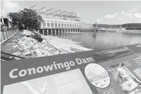  ?? KENNETH K. LAM, BALTIMORE SUN ?? Exelon and the Hogan administra­tion clashed over management of the flow through the Conowingo Dam after record rainfall in 2018 sent debris into the Chesapeake Bay.