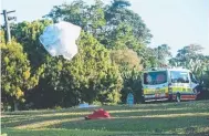  ?? Pictures: SUSAN KELLY/CATERS NEWS; CHRIS HOLMES ?? Skydivers land safely at Mission Beach yesterday before the tragedy which killed three people; Kerri Pike with her husband Alister; and the scene where Ms Pike and two others fell to their deaths.