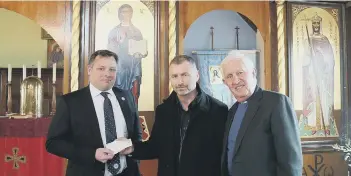  ?? ?? Peterborou­gh United representa­tives David Paton (left) and club chaplain Richard Longfoot hand over the cheque to St Olga’s in Woodston. Below: The two captains take to the field for the FA Cup tie