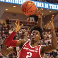  ?? (College Station Eagle/AP/ Michael Miller) ?? Texas A&M’s Emanuel Miller (left) and Arkansas’ Adrio Bailey battle for a rebound Saturday at Reed Arena in College Station, Texas. The Razorbacks will open the SEC Tournament on Wednesday against Vanderbilt as the 11th seed.