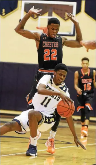  ?? PETE BANNAN — DIGITAL FIRST MEDIA ?? West Chester Rustin’s Tajir Asparagus falls as Chester’s Jordan Camper defends in nonleague action Tuesday in Westtown. Chester won 72-68.
