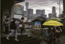  ?? Mark Schiefelbe­in / Associated Press ?? Masked commuters depart a subway station in Beijing. China’s leaders this week dismissed criticism of its virus policies.