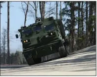  ?? (Arkansas Democrat-Gazette/Colin Murphey) ?? A M270 vehicle drives on an incline on the test track at the Lockheed Martin Camden Operations facility in Camden on Monday.