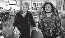  ??  ?? Lisa Sydnor, senior programs manager for The Salvation Army Central Oklahoma Area Command, and Esther Calhoun, senior center coordinato­r, visit with senior adults at the Reding Senior Center in south Oklahoma City.