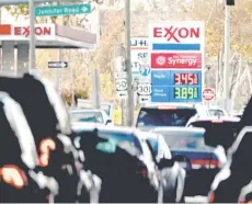  ?? — AFP photo ?? The price of gas is seen as traffic moves through Annapolis.