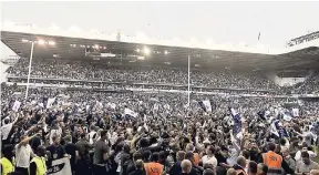  ?? AP ?? Fans invade the pitch after the English Premier League football match between Tottenham Hotspur and Manchester United at White Hart Lane stadium in London yesterday. Tottenham won 2-1. It was the last Spurs match at the old stadium, a new stadium is...