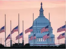  ?? J. DAVID AKE/THE ASSOCIATED PRESS ?? Flags fly at half-mast in honour of Sen. John McCain at the U.S. Capital at daybreak in Washington.