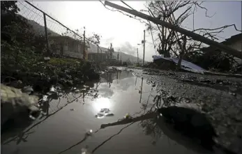  ??  ?? Downed power lines and debris are seen in the aftermath of Hurricane Maria in Yabucoa, Puerto Rico, on Tuesday. Governor Ricardo Rossello and Resident Commission­er Jennifer Gonzalez, the island’s representa­tive in Congress, have said they intend to...