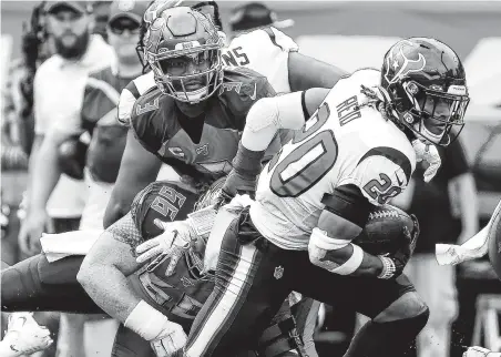  ??  ?? Texans strong safety Justin Reid (20) races past Buccaneers center Ryan Jensen (66) with an intercepti­on return.