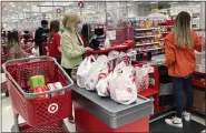  ?? NAM Y. HUH — THE ASSOCIATED PRESS FILE ?? Shoppers in a Target store in Vernon Hills, Ill.. Americans cut their spending in May compared with the month before, underscori­ng how surging costs of necessitie­s is causing them to be more cautious about buying discretion­ary items.